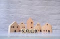 Miniature house and wooden blocks with the word sold on marble table.Real estate concept.Rent apartment. Property. Rental, renting Royalty Free Stock Photo