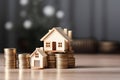 Miniature house wooden model on a stack of coins.