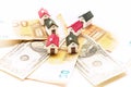 Miniature houses on euro and dollar bills Royalty Free Stock Photo