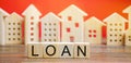 Miniature houses with the word Loan. The concept of mortgage housing and real estate loans. Buy an apartment on credit. Leasing.