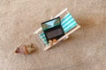 Miniature laptop on a miniature blue deck chair. Freelance Part time Outsources Job Employment Concept. Work on travel