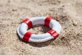 Miniature lifebuoy on sand Royalty Free Stock Photo