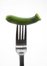 MINIATURE LONG COURGETTE OR MINIATURE ZUCCHINI AGAINST WHITE BACKGROUND