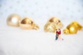 Miniature lover couple with background gold-yellow-gilter christmas ball, merry chistmas and happy new year concept