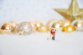 Miniature lover couple with background gold-yellow-gilter christmas ball, merry chistmas and happy new year concept