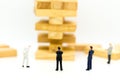 Miniature man: Group businessman and high wooden block. Image use for risk in business, marketing, investment concept