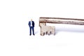 Miniature man with key Royalty Free Stock Photo