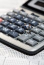 Miniature men shaking hands on a calculator Royalty Free Stock Photo