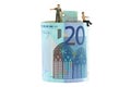 2 miniature men standing and sitting on a roll of Euro banknote