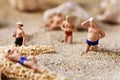 Miniature men in swimsuit on the beach