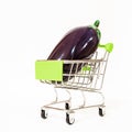 Miniature metal supermarket cart with glossy ripe eggplant isolated background Royalty Free Stock Photo