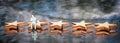 Miniature model of businessman sitting on one of the wooden five stars shape on reflective table.