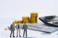 Miniature model of co-investment business people standing on business report graph. Financial and investment concept Royalty Free Stock Photo