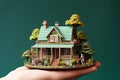 Miniature model of house in human hand, real estate concept. Royalty Free Stock Photo