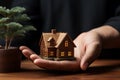 Miniature model of house in human hand, real estate concept. Royalty Free Stock Photo
