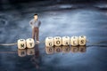 Miniature model of man and wooden cubes with my goals inscription strung on a thread