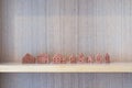 Miniature model terracotta house on wooden shelf interior home and living decoration building with copy space. Concept planning Royalty Free Stock Photo