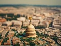 Miniature model of United States Capitol building, with its iconic dome and gold-colored top. This small replica is