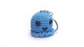 Miniature octopus keychain in blue colors crocheted on a white background