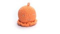 Miniature octopus keychain in orange colors crocheted on a white background