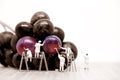 Miniature painters coloring red grapes. Macro photo Royalty Free Stock Photo