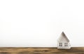 Miniature paper house on a wooden table. Concept