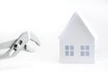 Miniature paper house. Wrench. Home renovation and services concept