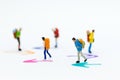 Miniature people : Backpacker group walking follow arrow. Image use for travel, business concept