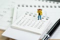 Miniature people, backpacker man figure standing on 2018 calenda