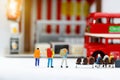 Miniature people with baggage waiting for bus. Transportation, t
