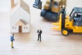 Miniature people : Banker seize asset. Forced eviction and confiscation Royalty Free Stock Photo