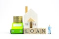 Miniature people : Banker stand near wood block words LOAN