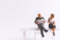 Miniature people business concept sitting on chair with a space Royalty Free Stock Photo