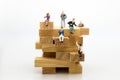 Miniature people: Business people sitting on puzzle pieces. Image use for find the answer of question, education , business Royalty Free Stock Photo