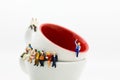 Miniature people : Business team sitting on cup of coffee and having a coffee break. Image use for business concept Royalty Free Stock Photo