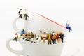 Miniature people : Business team sitting on cup of coffee and having a coffee break. Image use for business concept Royalty Free Stock Photo