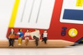 Miniature people: Business team sitting on the pencil with floppy disk drive for background, reading news paper, using as backgrou Royalty Free Stock Photo