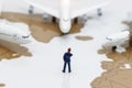 Miniature people: Business team standing in front of airplane. B Royalty Free Stock Photo