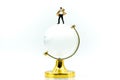 Miniature people : Businessman with glass globe. Royalty Free Stock Photo