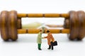 Miniature people: Businessman hand shake with hourglass background. Image use for time to invest in a business