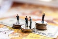 Miniature people: Businessman handshake with coins stack on world map, Investment, agreement, partnership and business concept