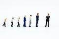 Miniature people: Businessman looking for employees for job placement. Image use for choice of the best suited employee, job Royalty Free Stock Photo