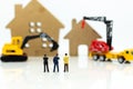 Miniature people: Businessman meeting for building home . Image use for construction, business concept