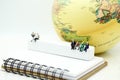 Miniature people : businessman reading newspaper sitting with bo Royalty Free Stock Photo