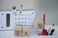 Miniature businessman sit on calculator for think pay annual income TAX year