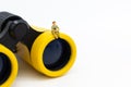 Miniature people : Businessman sitting on a binoculars. Image use for a foresight, business concept