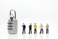 Miniature people: Businessman sitting on master key encoding. I Royalty Free Stock Photo