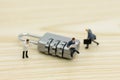 Miniature people: Businessman sitting on master key encoding. Image use for background security system, hack, business concept Royalty Free Stock Photo