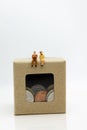 Miniature people: Businessman sitting on money box , profit margins of background. Image use for business solution concept