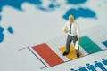 Miniature people businessman standing on bars graph as business Royalty Free Stock Photo